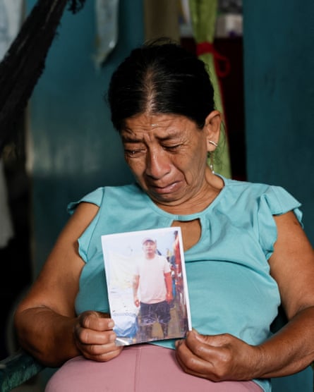 Woman crying holds photo in her hand