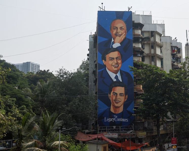 A mural featuring Reliance Industries founder Dhirubhai Ambani, Reliance Industries chairman and managing director Mukesh Ambani, and Reliance Jio Infocomm chairman Akash Ambani on a building ahead of the Jio Platforms IPO listing ceremony in Mumbai, India, Oct 21, 2026. (Photo: Reuters/Francis Mascarenhas)