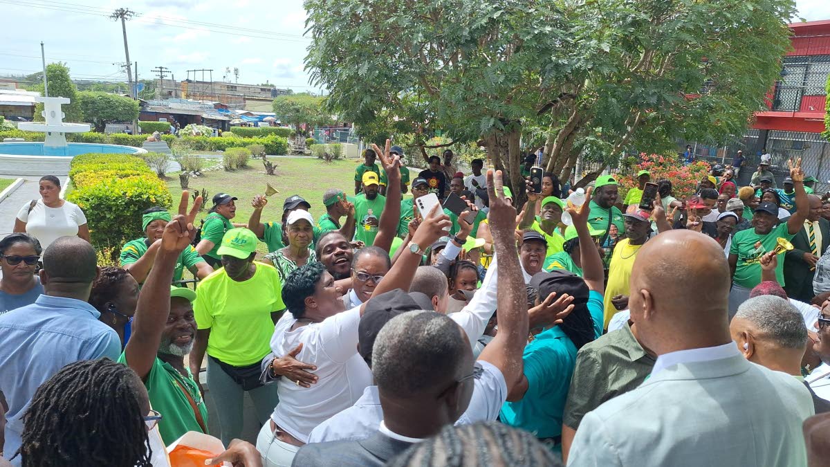 Jamaica Labour Party supporters greeting Mayor Joel Williams following the adjournment of the meeting on Friday.